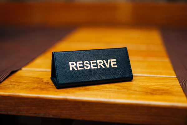 Sign reserve on a wooden table in a restaurant. High quality photo